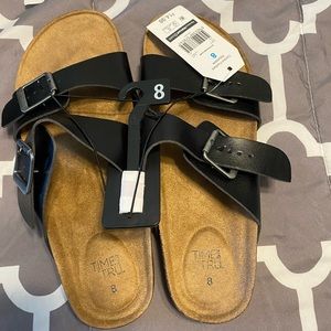 Black sandals with tags